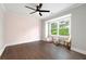 Bedroom with hardwood floors, a modern ceiling fan, and large windows offering scenic outdoor views at 550 Stewart Nw Ave, Marietta, GA 30064