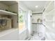 Spacious walk-in closet with custom shelving, marble floors, and a window offering natural light and street views at 550 Stewart Nw Ave, Marietta, GA 30064