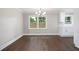 A formal dining room showcasing newly refinished wood floors and natural light at 550 Stewart Nw Ave, Marietta, GA 30064
