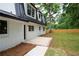 Exterior side view of a modern home with a metal roof, highlighting the new patio and fenced backyard at 550 Stewart Nw Ave, Marietta, GA 30064