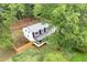An aerial view of a modern home with a metal roof and a spacious, tree-lined backyard at 550 Stewart Nw Ave, Marietta, GA 30064