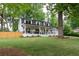 Charming two-story home with a welcoming front porch and a lush green lawn at 550 Stewart Nw Ave, Marietta, GA 30064