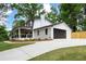 Charming home featuring a well-manicured lawn, modern design, and a convenient garage at 550 Stewart Nw Ave, Marietta, GA 30064