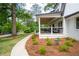 Inviting front porch with seating area, complemented by manicured landscaping and a walkway at 550 Stewart Nw Ave, Marietta, GA 30064