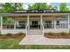 Inviting front porch with seating area, complemented by a lush, green lawn and landscaping at 550 Stewart Nw Ave, Marietta, GA 30064
