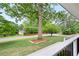 View from the porch showing the large front yard with mature trees enhancing the property's appeal at 550 Stewart Nw Ave, Marietta, GA 30064