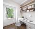 Bright home office featuring a built-in desk, floating shelves, hardwood floors and a large window for natural light at 550 Stewart Nw Ave, Marietta, GA 30064