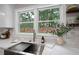 Kitchen sink featuring a stainless steel basin and view to the backyard through a large window at 550 Stewart Nw Ave, Marietta, GA 30064