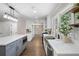 This kitchen features custom cabinets, stainless steel appliances, quartz countertops and a center island at 550 Stewart Nw Ave, Marietta, GA 30064