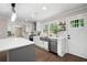 Modern kitchen with stainless appliances, quartz countertops, gray cabinets, and stylish lighting at 550 Stewart Nw Ave, Marietta, GA 30064