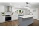 Kitchen with stainless steel appliances, island with quartz countertops, and gray shaker cabinets at 550 Stewart Nw Ave, Marietta, GA 30064