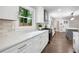 Bright kitchen featuring white cabinetry, quartz counters, stainless steel appliances, and a view of the yard at 550 Stewart Nw Ave, Marietta, GA 30064