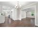 Open-concept floor plan with updated kitchen, dining area, and dark hardwood floors at 550 Stewart Nw Ave, Marietta, GA 30064