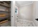 Bright laundry room showcasing built-in shelves and tiled floors, offering storage and functionality at 550 Stewart Nw Ave, Marietta, GA 30064