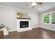 Bright living room featuring a white brick fireplace, dark hardwood floors, and large window at 550 Stewart Nw Ave, Marietta, GA 30064