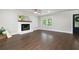 Spacious living room featuring hardwood floors, a fireplace and a view to the yard at 550 Stewart Nw Ave, Marietta, GA 30064
