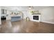 Spacious living room seamlessly flows into a modern kitchen, featuring a fireplace and hardwood floors at 550 Stewart Nw Ave, Marietta, GA 30064