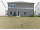 View of the backyard showing rear house elevation with door and windows at 2197 Boxwood Cir, Conyers, GA 30094