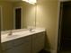 Bright bathroom with a double sink vanity, white cabinets, and a large mirror provides ample space at 2197 Boxwood Cir, Conyers, GA 30094