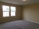 Bright bedroom with carpet, large windows, and neutral walls at 2197 Boxwood Cir, Conyers, GA 30094