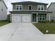 Charming two-story home with a two-car garage and a well-maintained front yard at 2197 Boxwood Cir, Conyers, GA 30094
