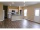 Open-concept kitchen and living room with modern appliances and wood-look flooring at 2197 Boxwood Cir, Conyers, GA 30094