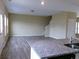 Bright living room with wood floors and a granite countertop island in kitchen at 2197 Boxwood Cir, Conyers, GA 30094