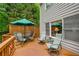 Back deck featuring an outdoor dining table with seating and additional lounge chairs at 3953 Lorien Nw Way, Kennesaw, GA 30152