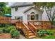 Multi-level deck and backyard with wooden stairs, offering a charming transition to the green lawn at 3953 Lorien Nw Way, Kennesaw, GA 30152