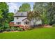 Expansive backyard featuring a wooden deck, lush green lawn, and mature trees, ideal for outdoor living and entertaining at 3953 Lorien Nw Way, Kennesaw, GA 30152