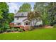 Exterior view of the home from the backyard showcasing the deck and lush landscaping at 3953 Lorien Nw Way, Kennesaw, GA 30152