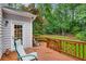 An inviting outdoor deck space with railing and seating, overlooking a lush and well-maintained backyard lawn area at 3953 Lorien Nw Way, Kennesaw, GA 30152
