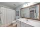 Bright bathroom with white vanity, large framed mirror, and shower with white curtain at 3953 Lorien Nw Way, Kennesaw, GA 30152