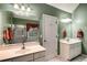 Well-lit bathroom with dual sinks, large mirrors, and separate shower and tub at 3953 Lorien Nw Way, Kennesaw, GA 30152