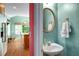 Charming powder room with pedestal sink and a glimpse into the light-filled breakfast nook at 3953 Lorien Nw Way, Kennesaw, GA 30152