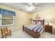 Inviting bedroom with a full-size bed, rocking chair, and large window at 3953 Lorien Nw Way, Kennesaw, GA 30152