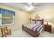 Bedroom with a large window, wood flooring, and a bed with blue, yellow, and red sheets at 3953 Lorien Nw Way, Kennesaw, GA 30152