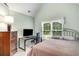 Bedroom with computer desk, large window, and neutral paint at 3953 Lorien Nw Way, Kennesaw, GA 30152