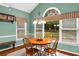 Bright dining area with a round wood table, natural light from large windows, and green painted walls at 3953 Lorien Nw Way, Kennesaw, GA 30152