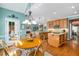 Charming dining area featuring a wooden table set, with views of the open kitchen and seamless access to outdoor patio at 3953 Lorien Nw Way, Kennesaw, GA 30152