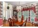 Formal dining room with hardwood floors, large windows, and a decorative chandelier at 3953 Lorien Nw Way, Kennesaw, GA 30152
