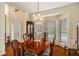 Formal dining room with wainscoting, decorative chandelier, and large windows for natural lighting at 3953 Lorien Nw Way, Kennesaw, GA 30152