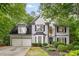 Charming two-story home with a well-manicured lawn, two-car garage and inviting front entrance framed by lush greenery at 3953 Lorien Nw Way, Kennesaw, GA 30152