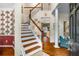Bright foyer boasts hardwood floors, a staircase, and an open view into the living spaces at 3953 Lorien Nw Way, Kennesaw, GA 30152