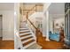 Grand foyer features hardwood staircase, leading to an open-concept living space at 3953 Lorien Nw Way, Kennesaw, GA 30152
