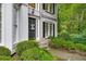 Charming front entrance with landscaped bushes, black door, and stone steps at 3953 Lorien Nw Way, Kennesaw, GA 30152