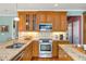 Updated kitchen features stainless steel appliances, granite countertops, and wood cabinetry at 3953 Lorien Nw Way, Kennesaw, GA 30152