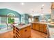 Open kitchen with granite countertops, stainless steel appliances, and island with seating, seamlessly connected to the living area at 3953 Lorien Nw Way, Kennesaw, GA 30152