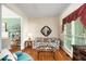 Cozy living room with hardwood floors, a floral sofa, and a view into another living space at 3953 Lorien Nw Way, Kennesaw, GA 30152