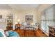 Cozy living room with large windows, hardwood floors, and a comfortable seating arrangement at 3953 Lorien Nw Way, Kennesaw, GA 30152
